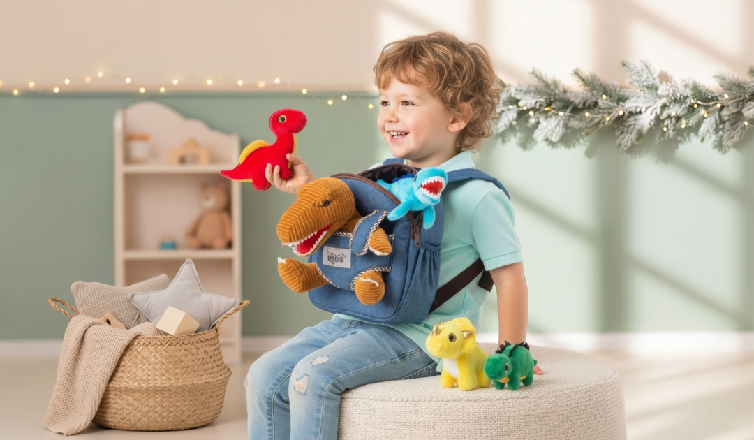 Toddler with the Naturally KIDS dinosaur backpack set: a small backpack, a corduroy plush T-Rex and mini plush dinosaurs, in a room decorated for the holidays